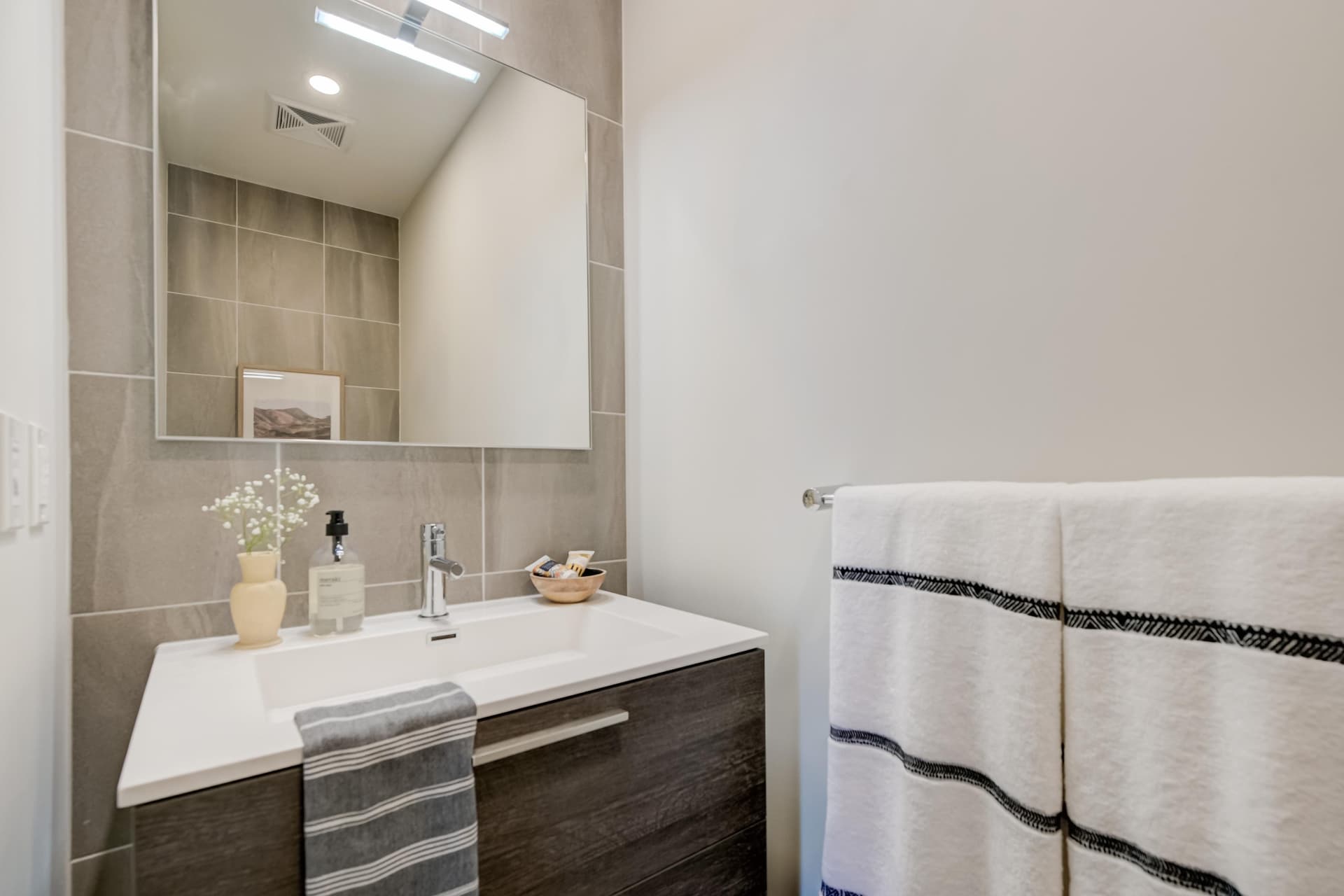 Second full washroom with floating vanity and tile surround