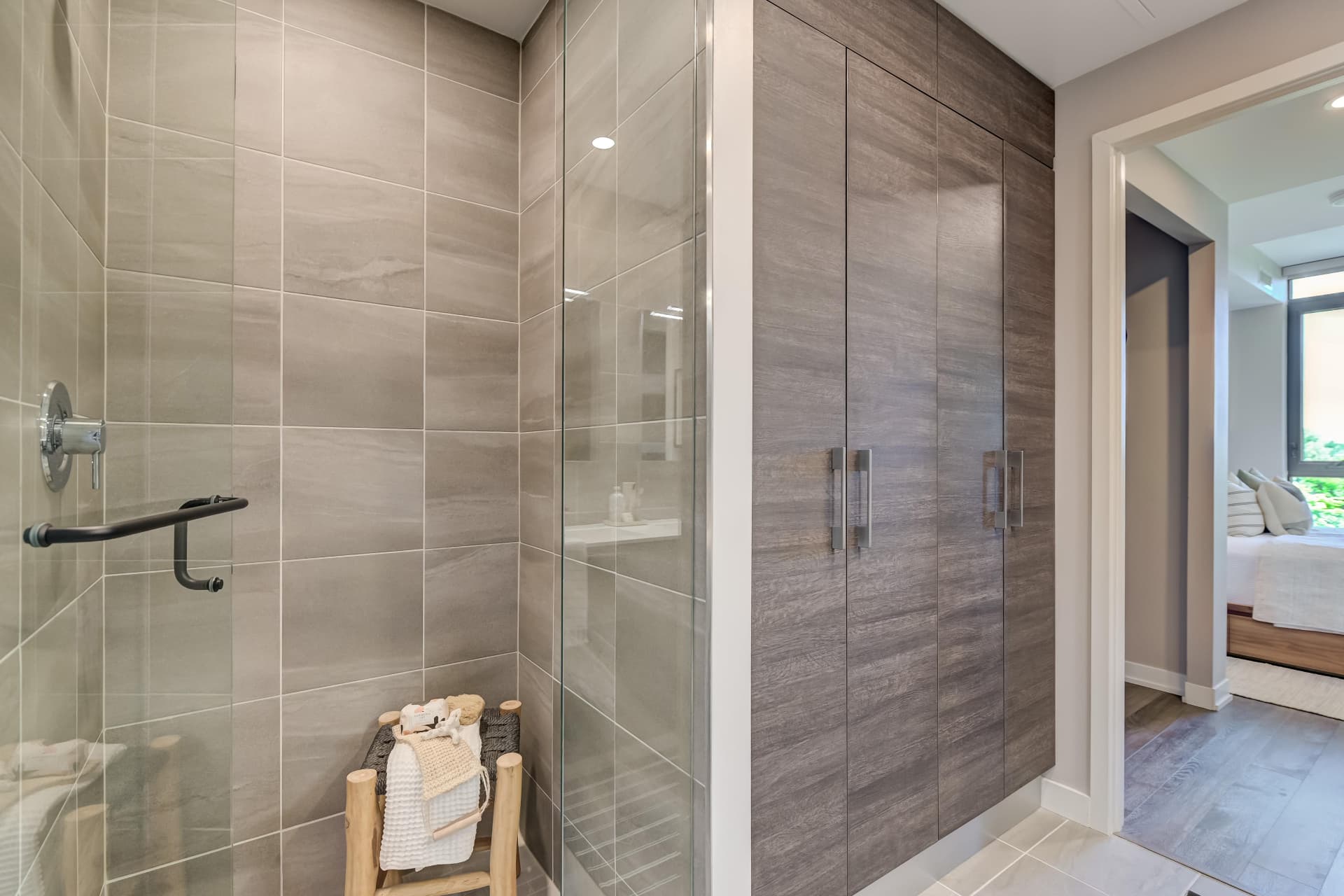 Ensuite glass shower with built-in niche and linen storage