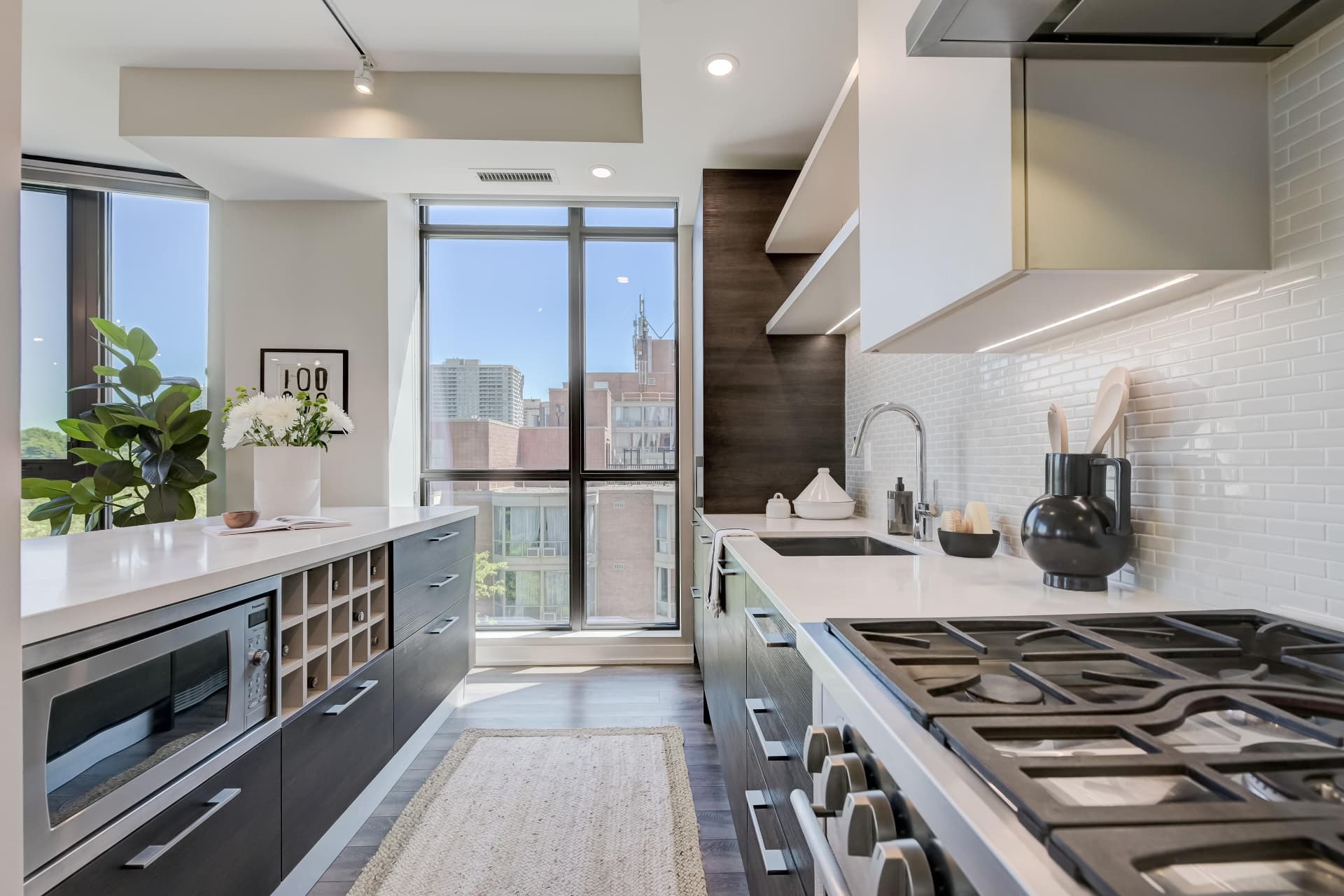 Galley kitchen with gas cooktop, quartz counters and wine storage