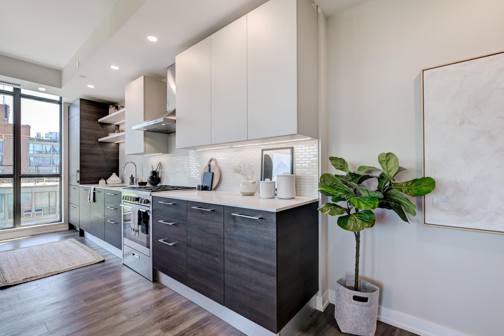 Scavolini kitchen with gas range, subway tile and upper cabinetry