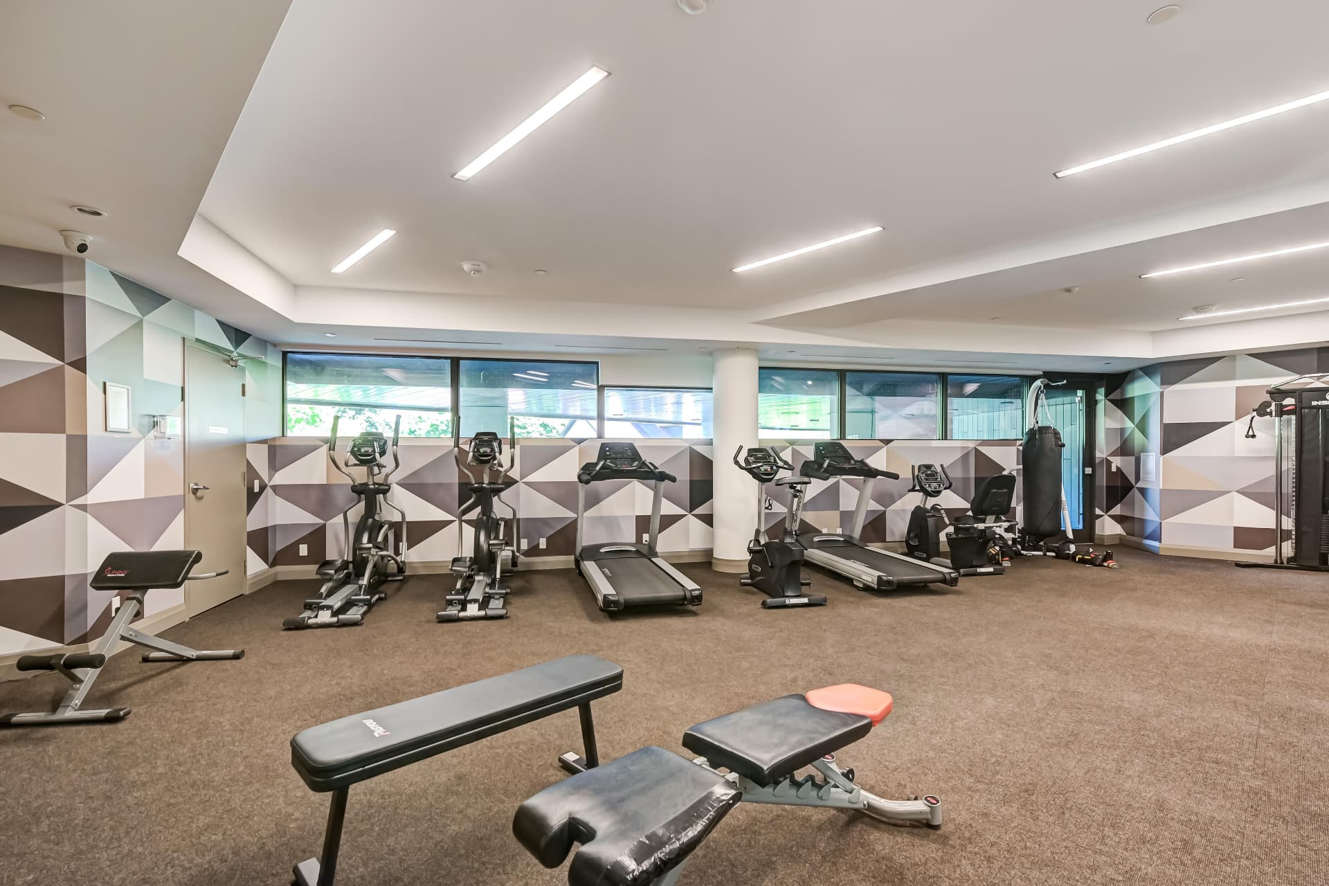 Residents' fitness centre with cardio equipment and free weights