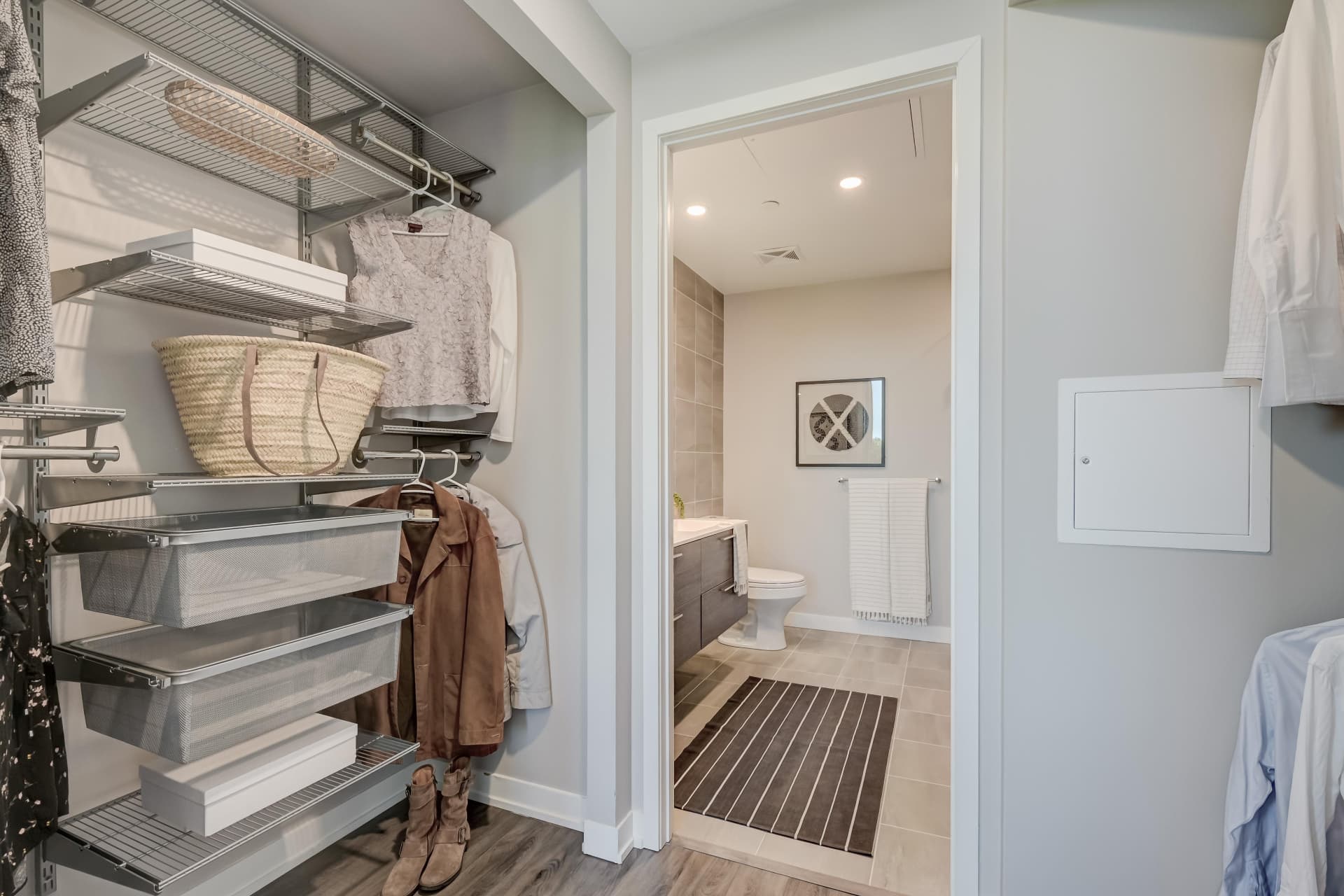 Walk-through closet with built-in shelving leading to the ensuite