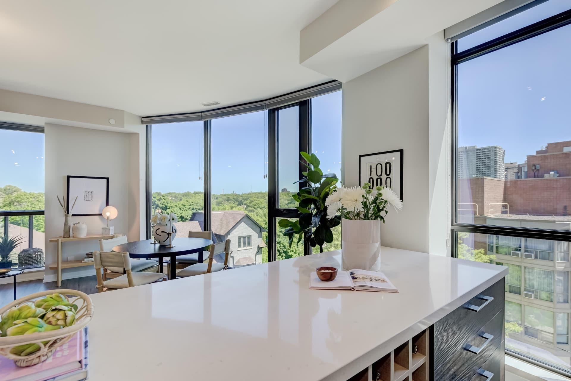 Breakfast bar with curved windows and treetop park views