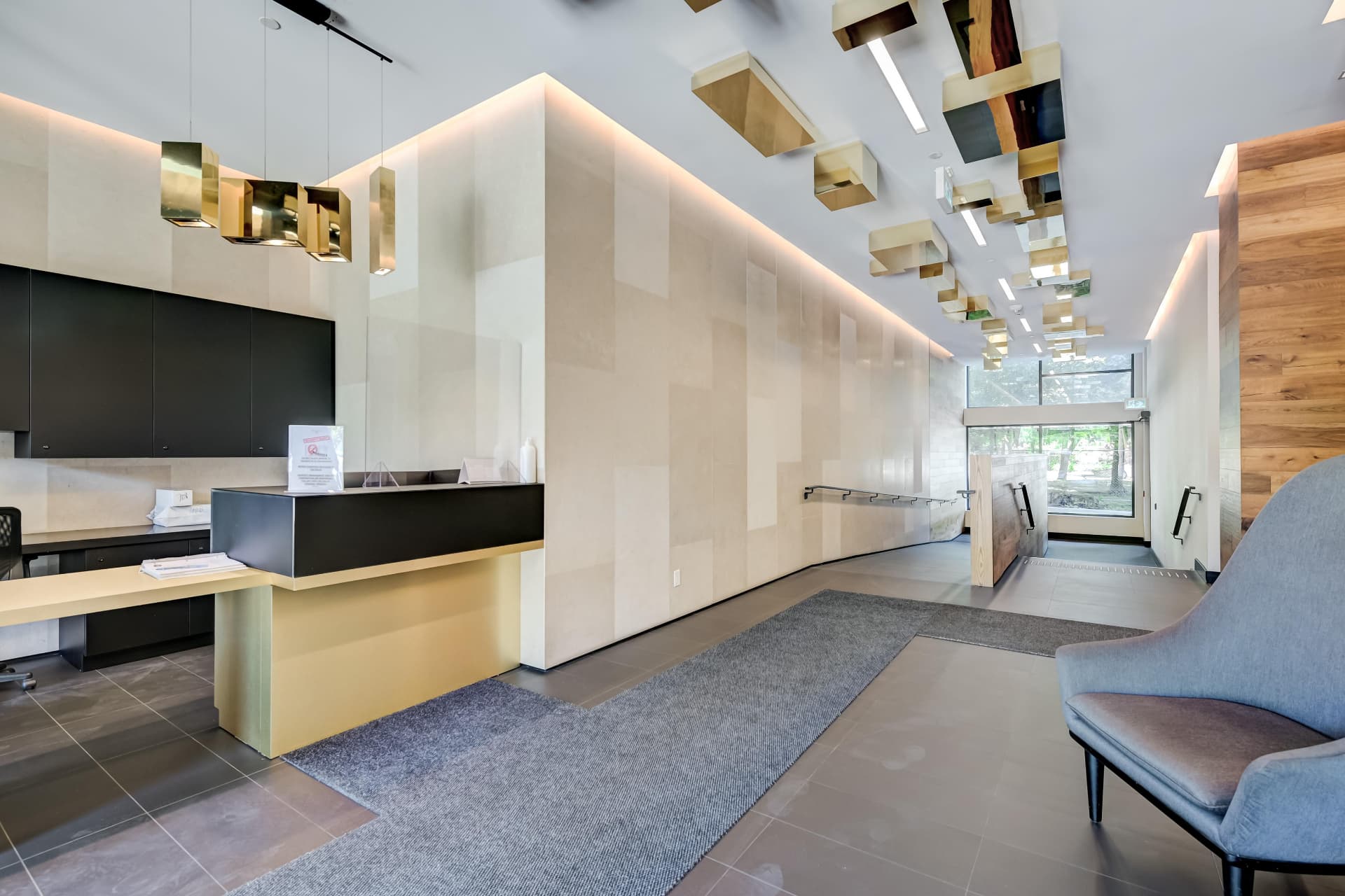 Picnic Condos lobby with concierge desk and designer lighting
