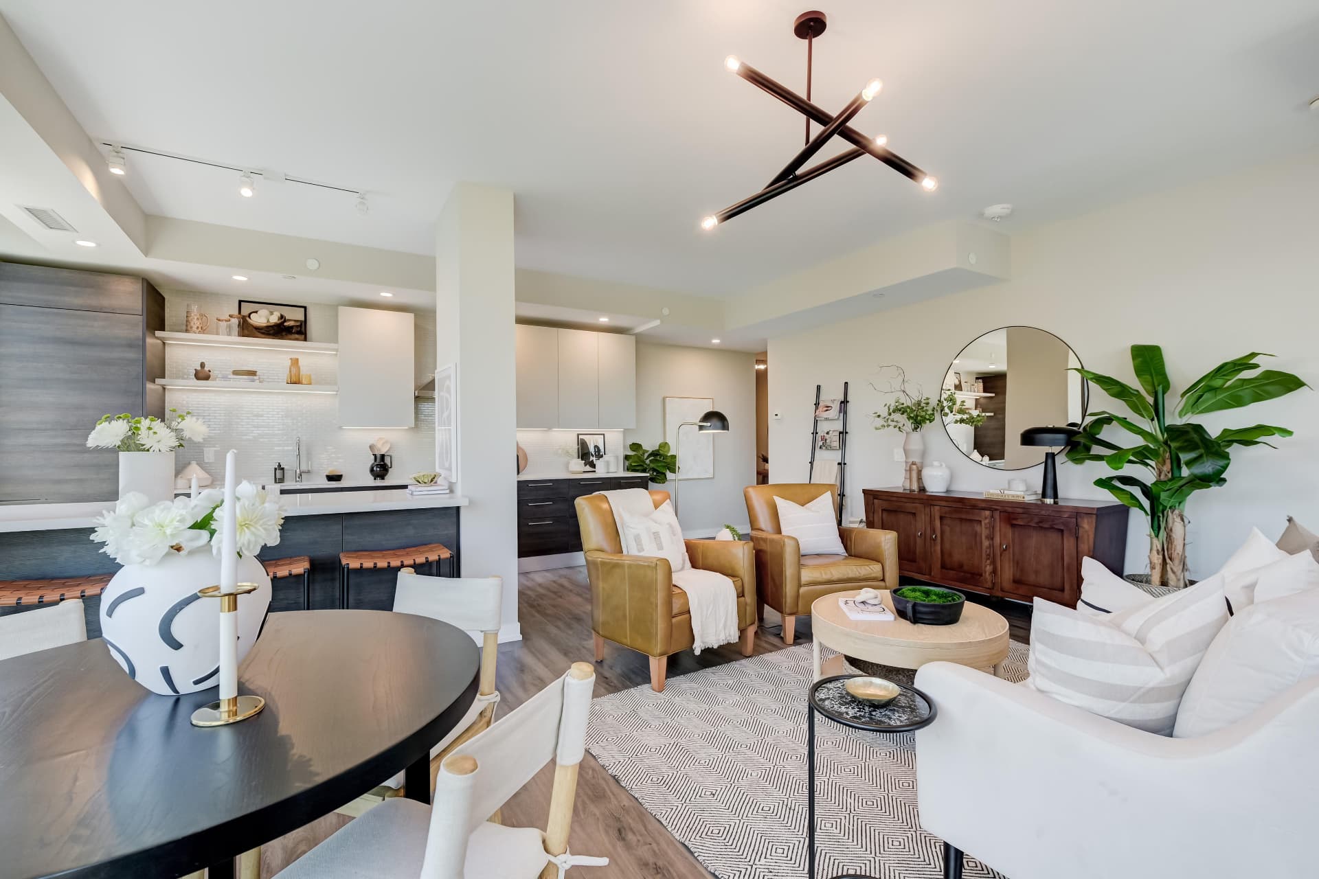 Dining table with the kitchen and living room beyond