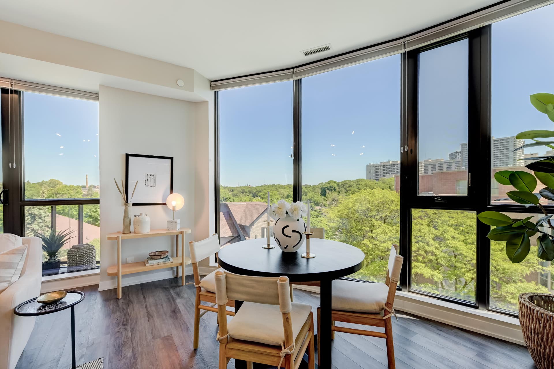 Corner dining space with treetop and skyline views