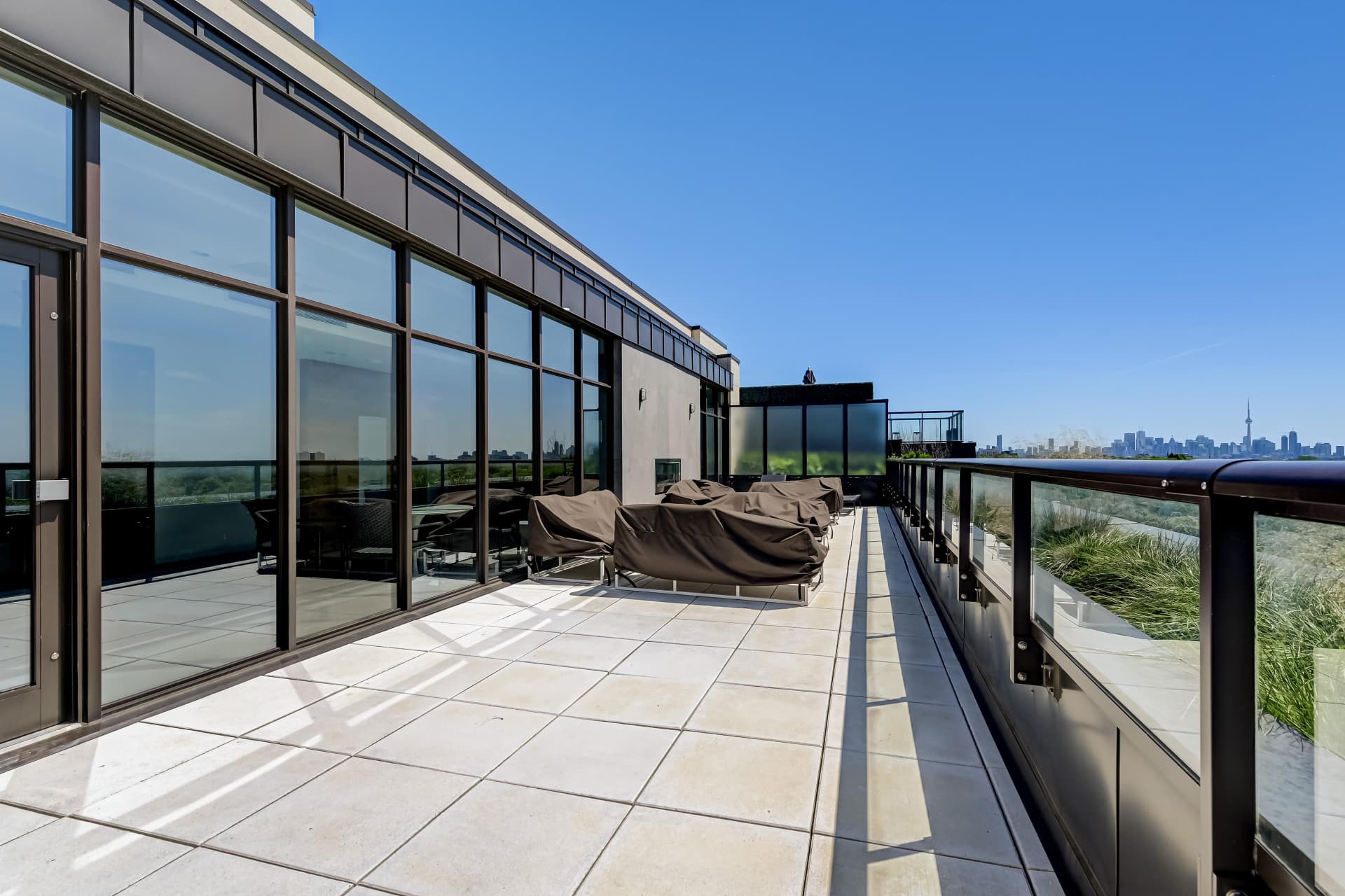 Rooftop terrace with loungers and downtown Toronto skyline views