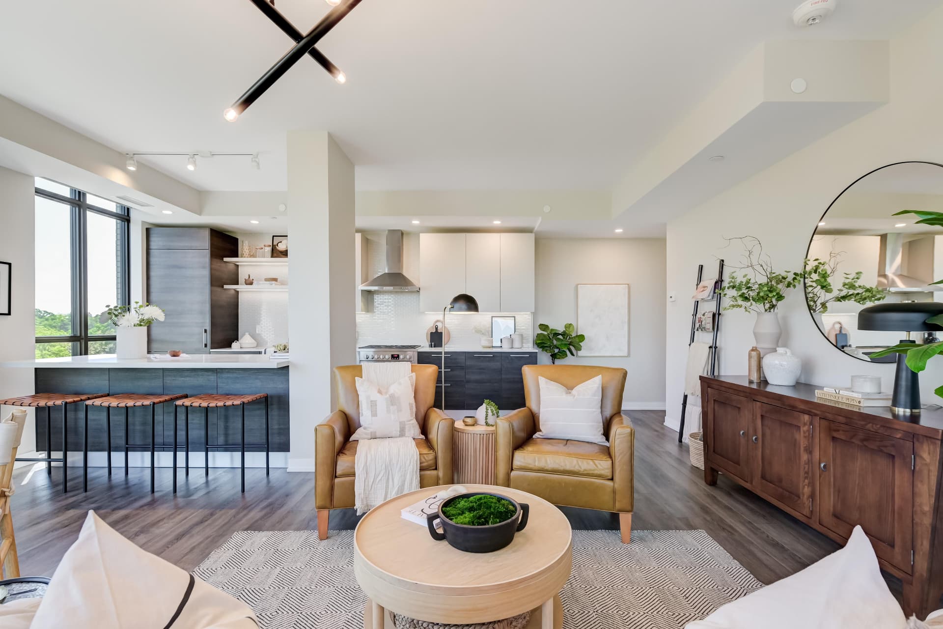 Kitchen with dark cabinetry, quartz counters and open shelving