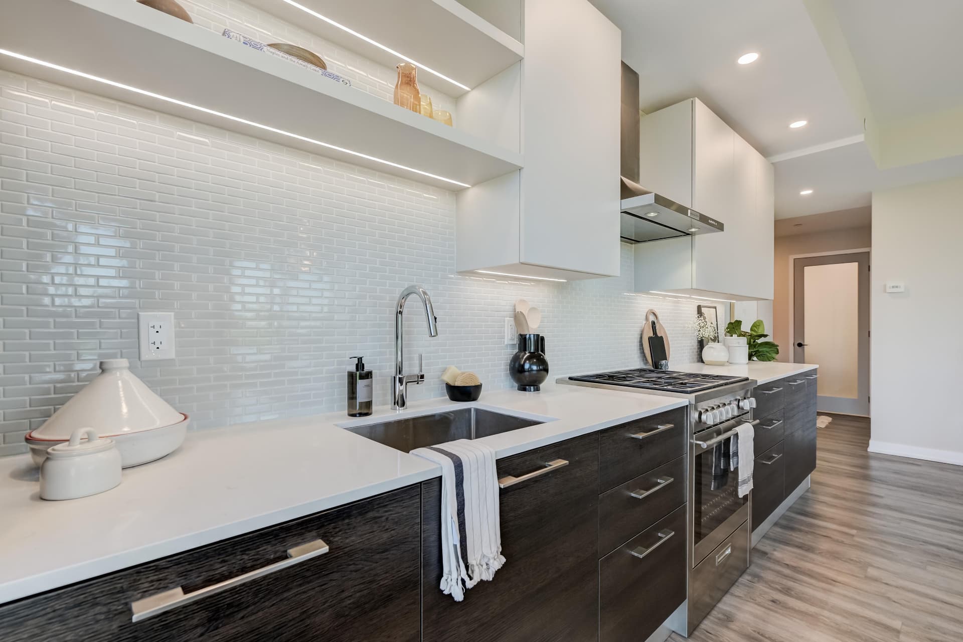 Undermount sink, quartz counters and glossy tile backsplash